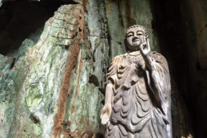 Stone standing Buddha in an alcove, Marble Mountains, Vietnam
