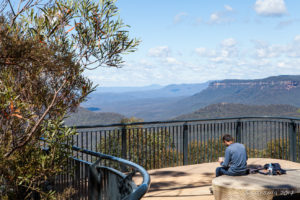 Man sitting at an overlook, Three Sisters, Katoomba Australia