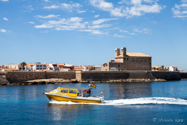 Yellow Taxi motoring in front of Tabarca, Spain