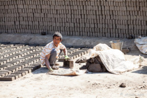 Nepali man forming bricks for sun-drying, Panauti-Namobuddha Rd, Nepal