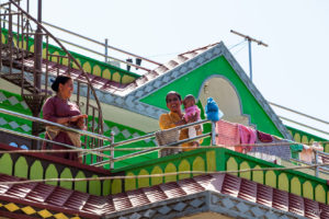 Nepali women on the balcony of a green house, Panauti-Namobuddha Rd, Nepal