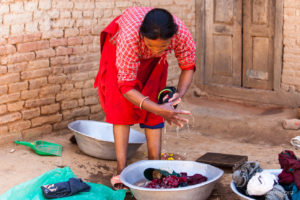 Nepali woman doing laundry, Panauti-Namobuddha Rd, Nepal