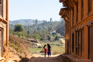 Two women chatting in the road, Panauti-Namobuddha Rd, Nepal