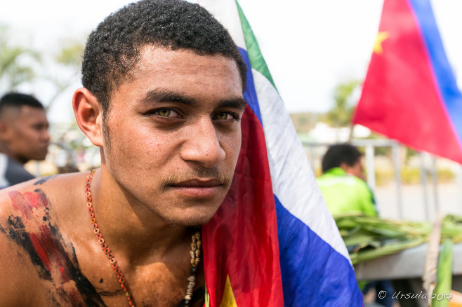 Portrait: Young Papuan man with a flag,, Port Moresby, Papua New Guinea 