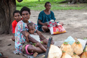 Women seated in the dirt at the Roadstop market, Maprik PNG