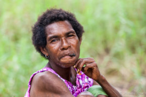Portrait: Papuan woman smoking a cheroot, Maprik PNG