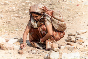 Indian woman in the ruins at the top of Amer Fort, Jaipur India