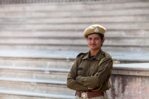 Indian woman in security uniform on the steps, Amer Fort, Jaipur India