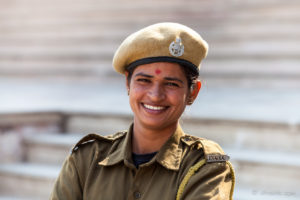 Portrait: Indian woman in security uniform on the steps, Amer Fort, Jaipur India