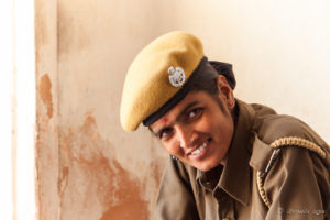Portrait: Indian woman in security uniform on the steps, Amer Fort, Jaipur India