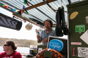 Captain Sponge on his canopied oyster punt, Pambula Australia