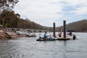 Jet Skis and riders at a Dock, Pambula River, Australia
