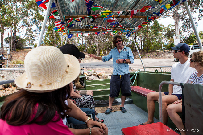 Brett Weingarth briefing passengers on his oyster punt, Landing Road, Pambula Australia