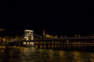 Széchenyi Chain Bridge and Matthias Church after dark from the Danube, Budapest Hungary