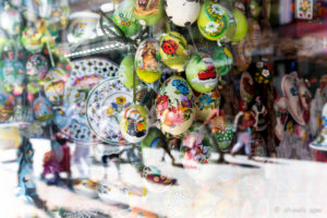 Painted eggs and plates in a shop window, Budapest Hungary