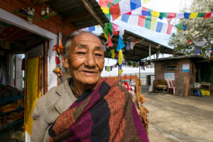 Old Tibetan-Nepali woman looking after a Shrine, Thrangu Tashi Yangtse Monastery, Namo Buddha Nepal