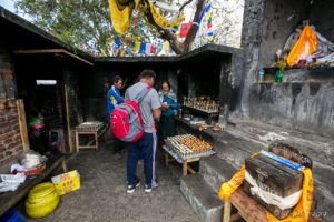 People in a shrine area, Prayer Lamps, Thrangu Tashi Yangtse Monastery, Namo Buddha Nepal