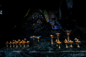 Candles and Coins at a dark shrine, Thrangu Tashi Yangtse Monastery, Namo Buddha Nepal