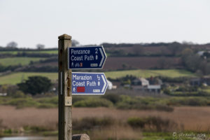 Walking and bicycle path signposts, Marazion beach, Cornwall UK.