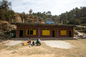 Children doing bookwork in the courtyard of a small community school, Namobuddha to Dhulikhel, Kathmandu Valley