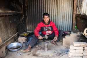 Man metalworking in a rough shed, Namobuddha to Dhulikhel, Kathmandu Valley