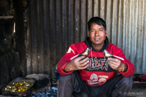Man with birds made from bone in a rough shed, Namobuddha to Dhulikhel, Kathmandu Valley