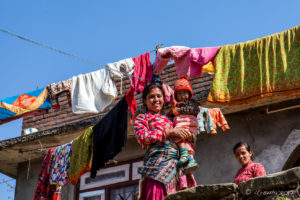Mother and children on the balcony of their house, Dhulikhel to Nagarkot, Nepal