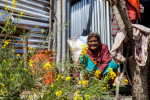 Old Nepali woman in her garden, Dhulikhel to Nagarkot, Nepal