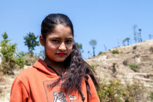 Portrait: Young Nepali woman on the steps of a hill, Dhulikhel to Nagarkot, Nepal