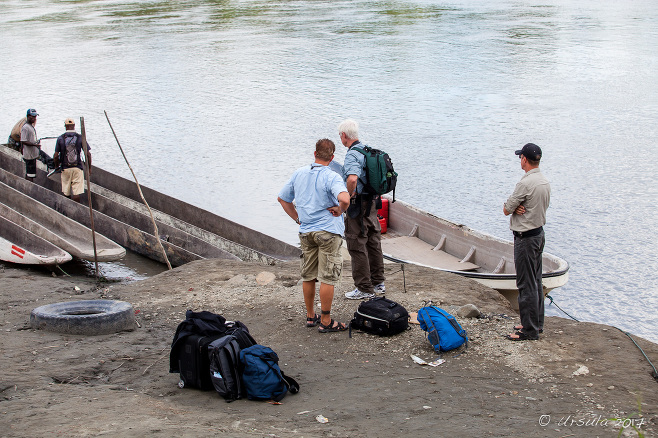 Tourists standing around dugout boats on the Sepik River, Papua New Guinea