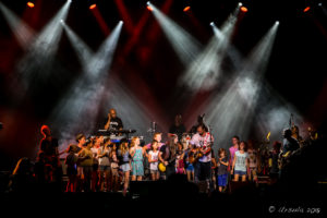 Michael Franti, Lukas Nelson, and audience children on stage at Bluesfest Byron Bay AU