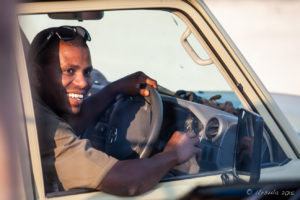 Smiling Namibia driver in his truck window, Etosha National Park, Namibia Africa