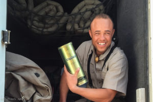 Portrait of a Namibian guide with his gold-brand brandy, Namibia