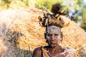 Old Mursi Woman in a Headdress of warthog tusks, Ethiopia