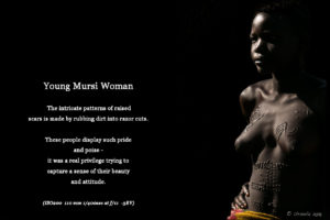 Underexposed bright-rim-light picture of a young Mursi woman, Ethiopia