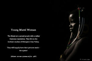 Underexposed bright-rim-light picture of a young Mursi woman, Ethiopia