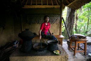 Young Balines woman pan-toasting coffee, Bali Indonesia