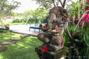 Stone Ganesh decorated with fresh flowers, Bali