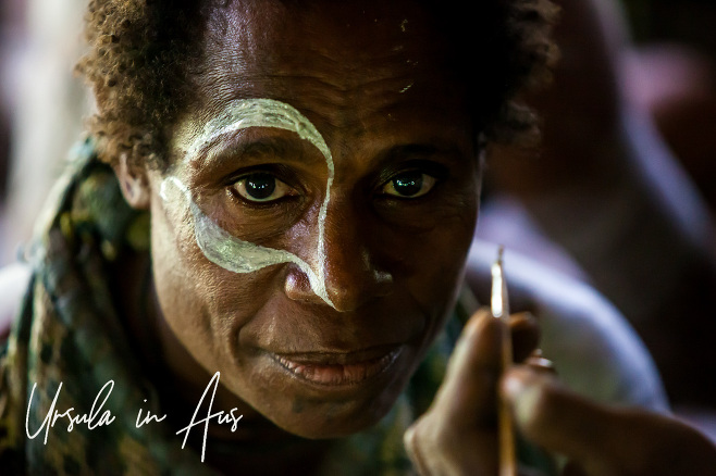 Papuan woman being face-painted, Kanganaman Village , PNG