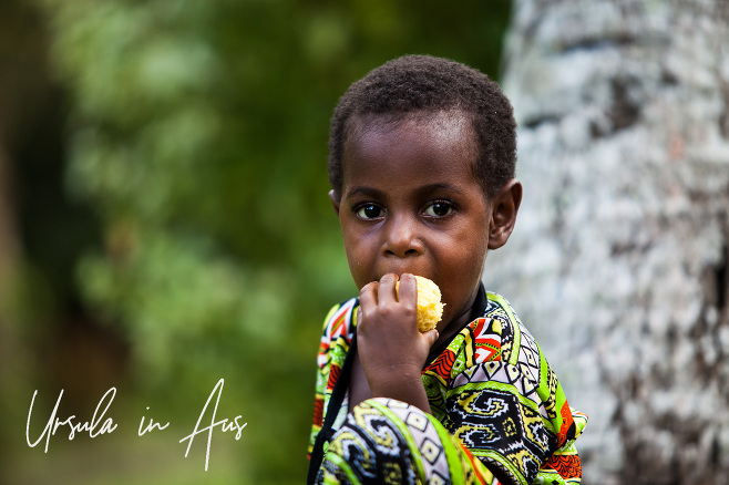 A Papuan boy eating, Kanganaman Village, PNG