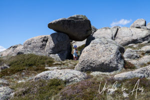 Girl in a granite rock tunnel, Mt Kosciuszko Lookout, Australia