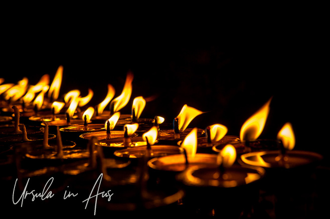Buddhist candles in the darkness, Boudhanath Stupa, Kathmandu, Nepal.