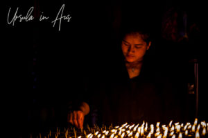 Nepali woman lighting candles, Boudhanath Stupa, Kathmandu.