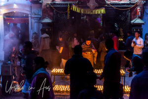 Tibetan Buddhists lighting candles at Boudhanath Stupa, Kathmandu.
