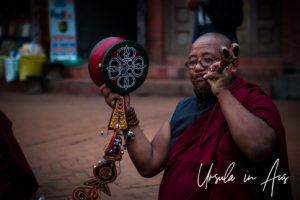Tibetan Buddhist monk playing music, Boudhanath Stupa, Kathmandu.