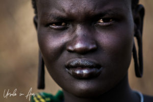 Young Mursi woman with stretched earlobes, Omo Valley Ethiopia