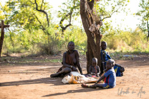 Mursi family group around a tree, Omo Valley Ethiopia