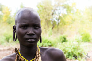 Portrait: Young Mursi mother, Omo Valley Ethiopia