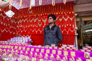 Man selling gold bangles and necklaces, Pushkar India