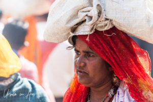 Indian Woman with a bag on her head, Pushkar, India